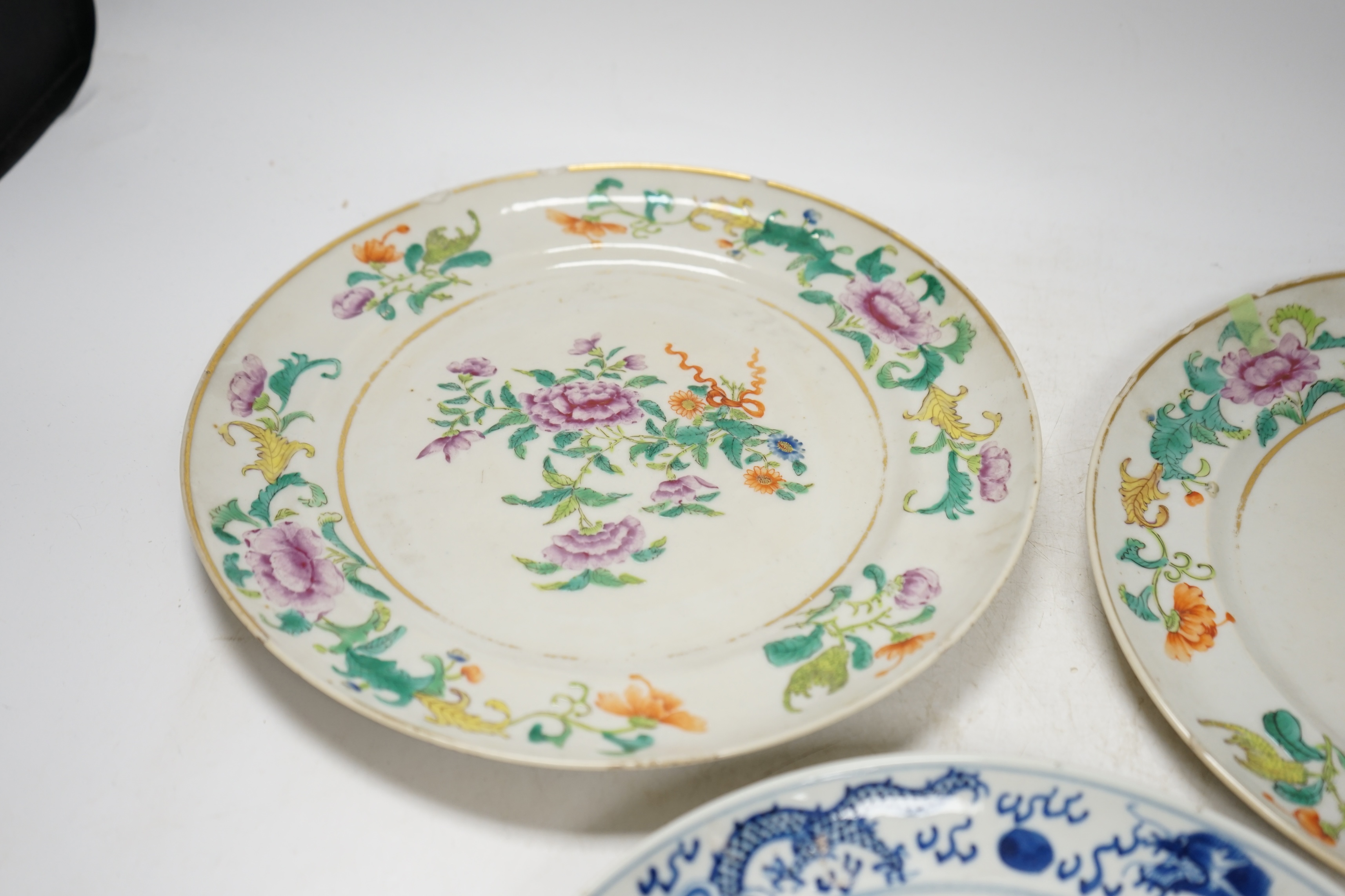 A pair of 19th century Chinese famille rose plates and another blue and white, largest 25cm diameter. Condition - blue and white good, others poor to fair